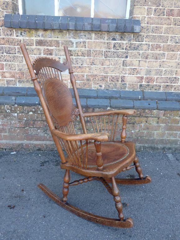 AN OAK ROCKING CHAIR, WITH PRESSED LEATHER SEAT