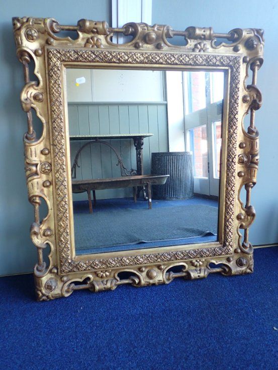 A MOULDED AND GILT FRAMED MIRROR