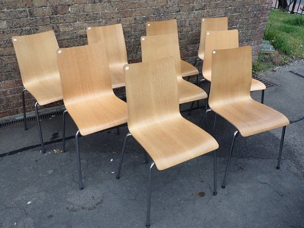 NINE MODERN ASH VENEERED PLY AND TUBULAR STEEL DINING CHAIRS