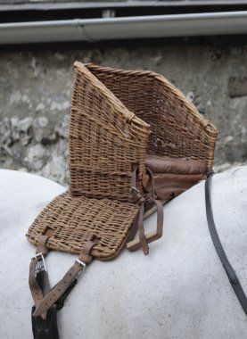 A VICTORIAN WICKER AND LEATHER CHILD'S BASKET SEAT