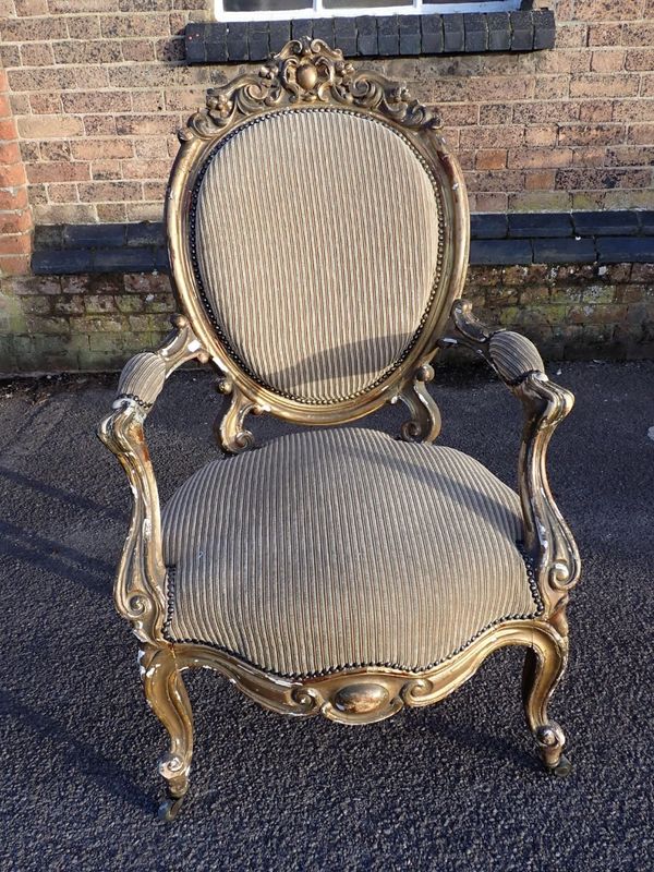 A VICTORIAN  MOULDED AND GILT GESSO OPEN ARMCHAIR