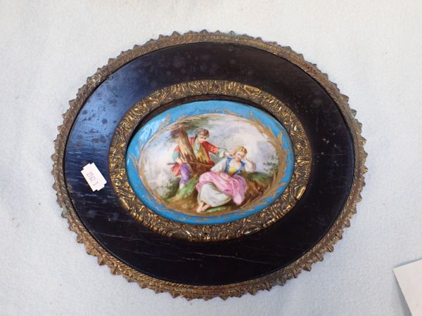 A 19TH CENTURY FRENCH PORCELAIN PLAQUE IN EBONISED AND GILDED FRAME