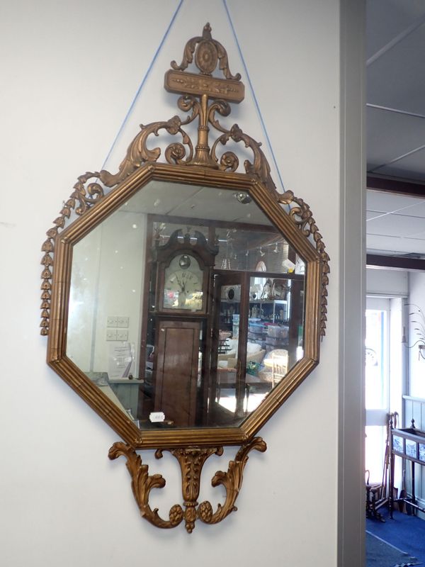 AN OCTAGONAL NEOCLASSICAL STYLE  GILT FRAMED MIRROR