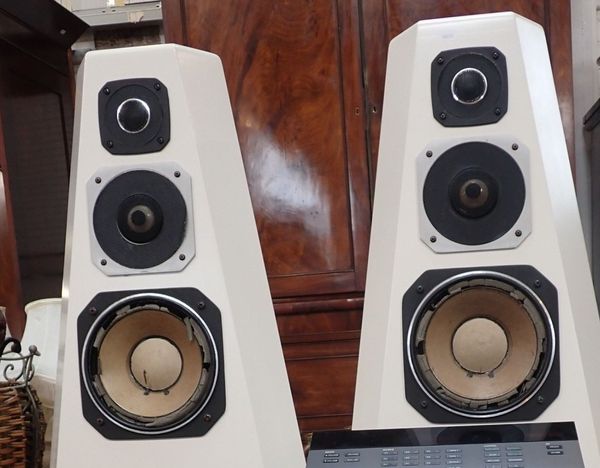 A PAIR OF WHITE BOLLARD SHAPED SPEAKERS