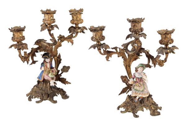 A PAIR OF CONTINENTAL GILT BRONZE AND PORCELAIN MOUNTED THREE LIGHT CANDELABRA IN ROCOCO REVIVAL TASTE