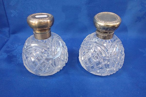 A PAIR OF SILVER MOUNTED LARGE PERFUME BOTTLES