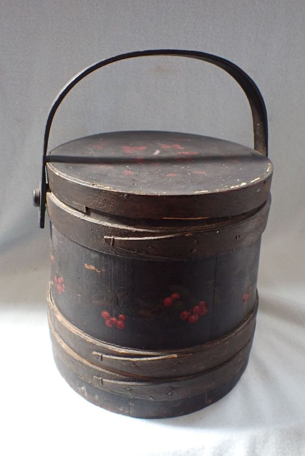 A WOODEN LIDDED BUCKET, PAINTED WITH CHERRIES ON A BLACK GROUND