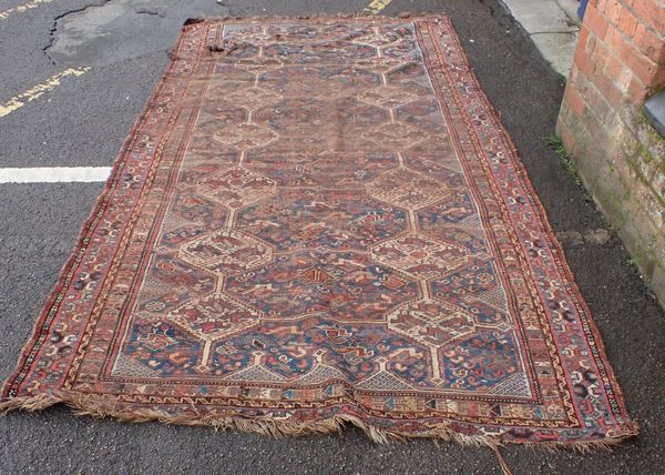 AN ANTIQUE SHIRAZ CARPET