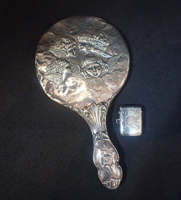AN EDWARDIAN SILVER BACKED HAND MIRROR