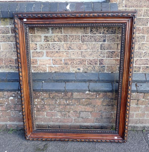 A LARGE CARVED WOODEN PICTURE FRAME