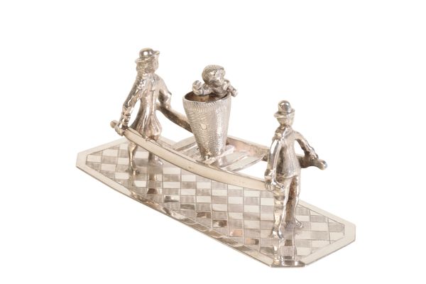 A DUTCH SILVER MINIATURE OF A CHILD BEING CARRIED IN A BASKET