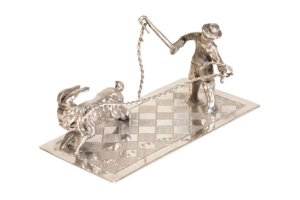 A DUTCH SILVER MINIATURE OF A MAN LEADING A GOAT