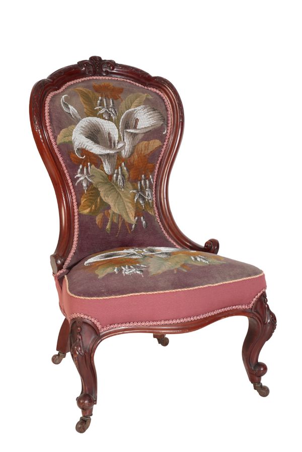 A VICTORIAN CARVED WALNUT AND UPHOLSTERED 'NURSING CHAIR',