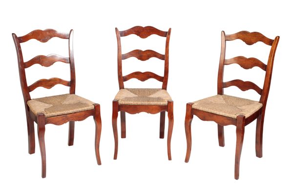 A SET OF EIGHT STAINED BEECH AND RUSH SEATED LADDER BACK CHAIRS,