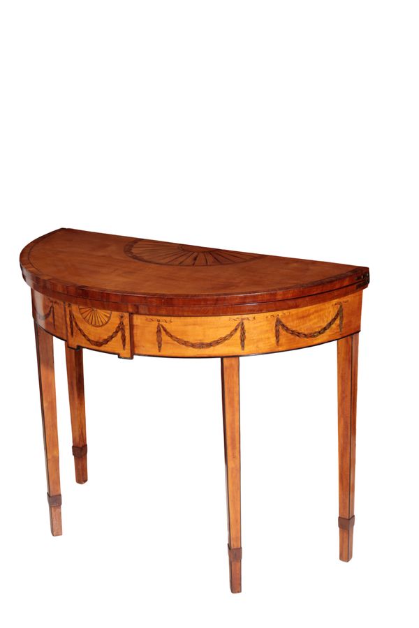 A SATINWOOD AND MARQUETRY DEMI-LUNE FOLDING CARD TABLE IN SHERATON TASTE,