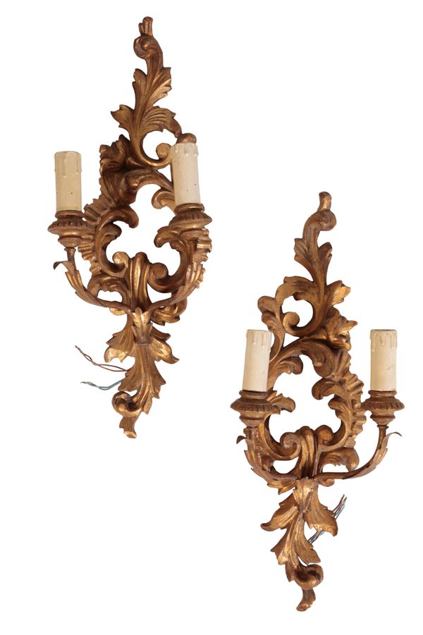 A PAIR OF CONTINENTAL CARVED AND GILTWOOD TWIN LIGHT WALL APPLIQUES, IN 18TH CENTURY STYLE,