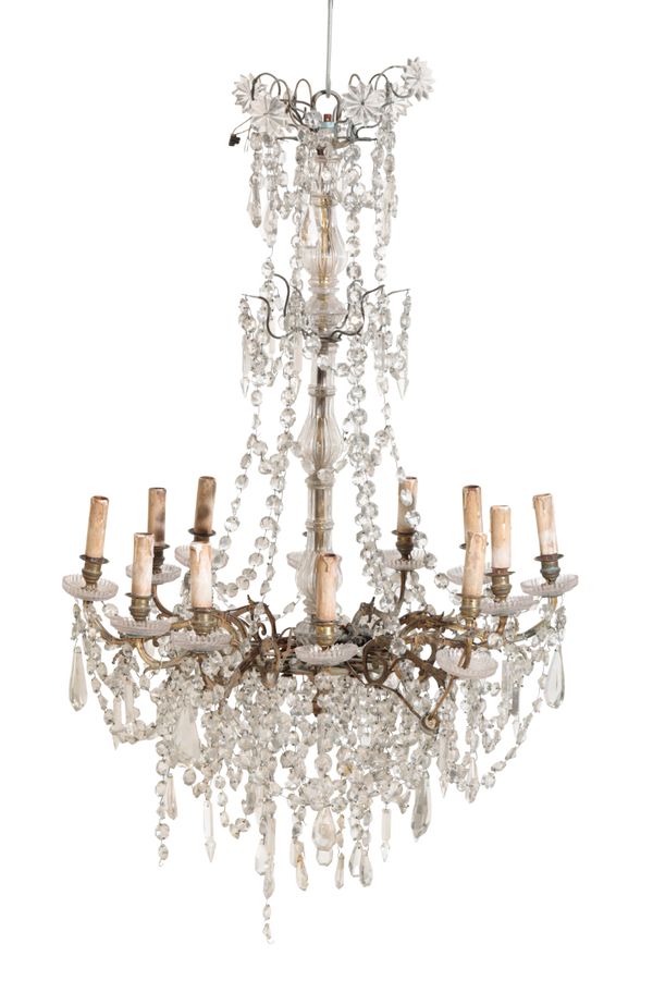 A GILT METAL AND GLASS ADORNED TWELVE LIGHT CHANDELIER,