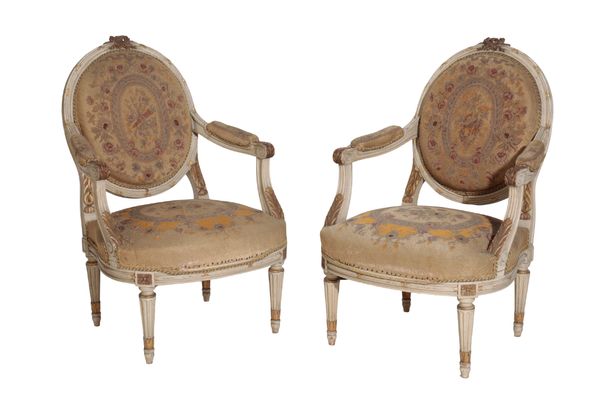 A PAIR OF CARVED, PAINTED AND PARCEL GILTWOOD FAUTEUILS, IN LOUIS XV TRANSITIONAL STYLE,