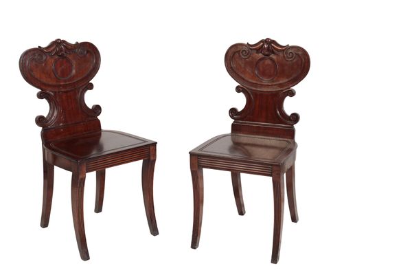 A PAIR OF LATE GEORGE III MAHOGANY HALL CHAIRS,