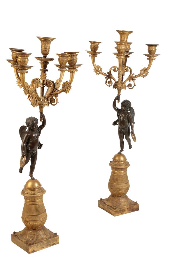 A PAIR OF RESTAURATION GILT AND PATINATED BRONZE FIGURAL FIVE LIGHT CANDELABRA,