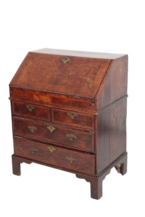 A GEORGE II WALNUT AND CROSSBANDED BUREAU,