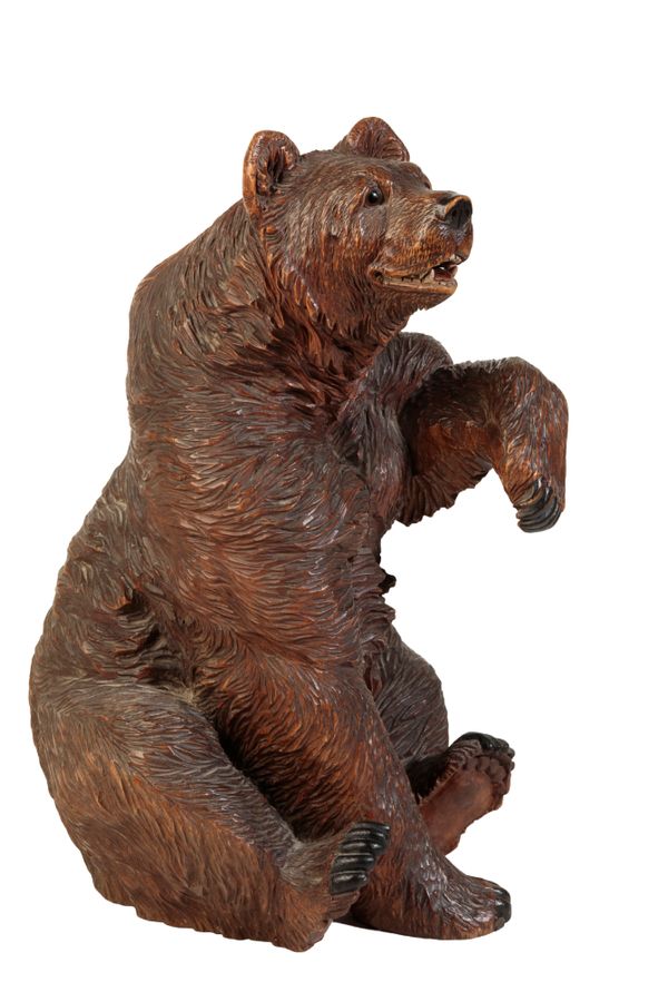 A 'BLACK FOREST' CARVED AND STAINED LINDEN WOOD MODEL OF A BEAR,