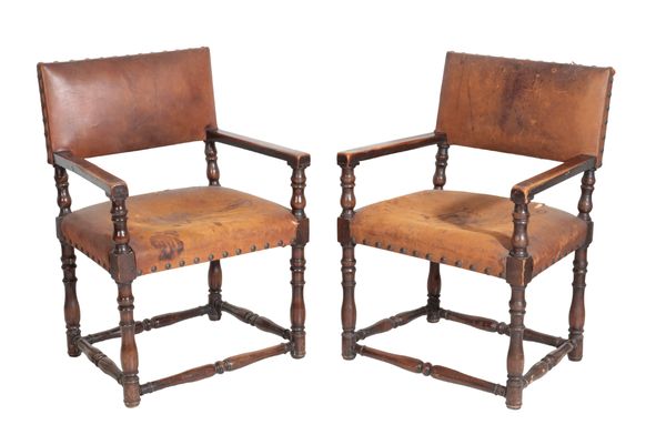 A PAIR OF WALNUT AND LEATHER UPHOLSTERED ELBOW CHAIRS, IN LATE 17TH CENTURY TASTE,