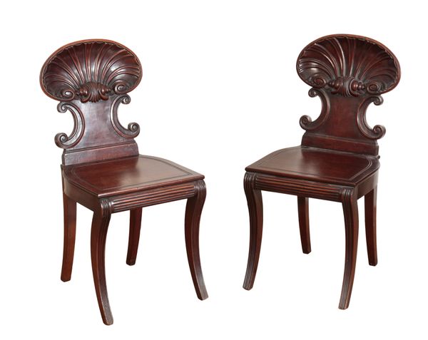 A PAIR OF GEORGE IV CARVED MAHOGANY HALL CHAIRS, IN THE MANNER OF GILLOWS,