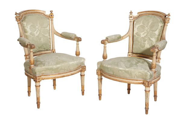 A PAIR OF CARVED, PAINTED AND PARCEL GILTWOOD FAUTEUILS, IN LOUIS XVI STYLE,