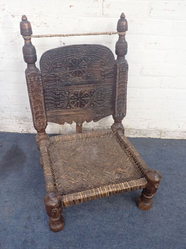 A NORTH AFRICAN TRIBAL LOW CHAIR