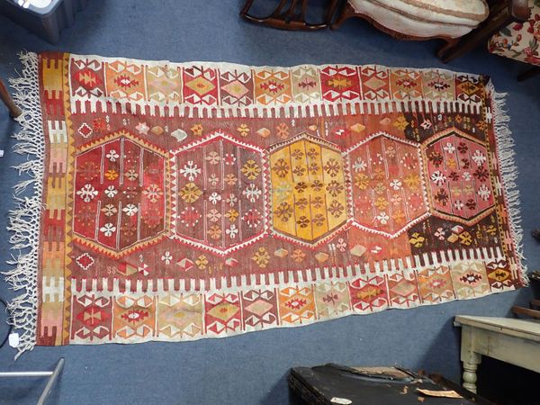 A KELIM, IN WARM PINKS AND YELLOWS