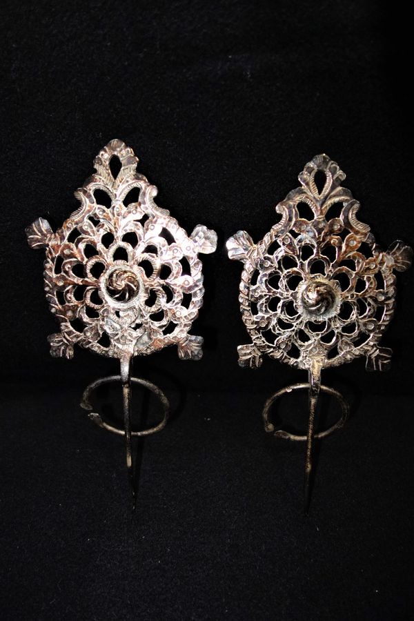 A PAIR OF EASTERN WHITE METAL ADORNMENTS