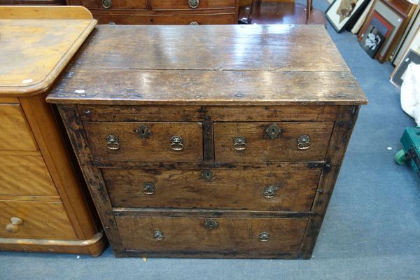 AN OAK CHEST OF DRAWERS