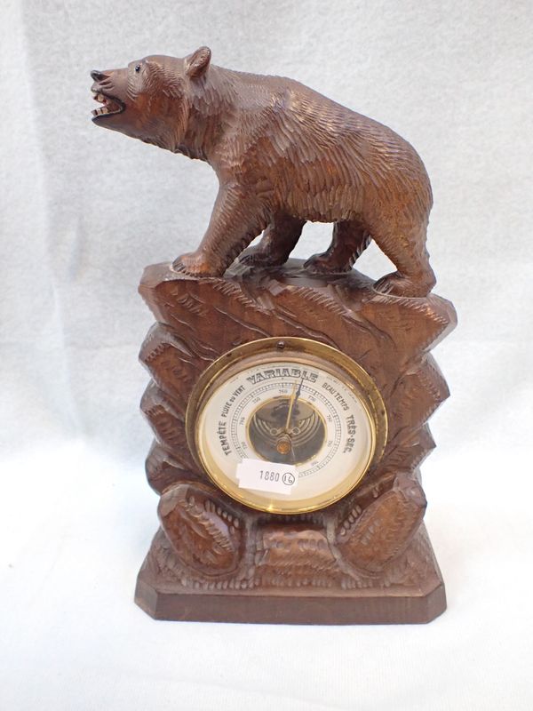 A BLACK FOREST CARVED WOODEN CASED BAROMETER