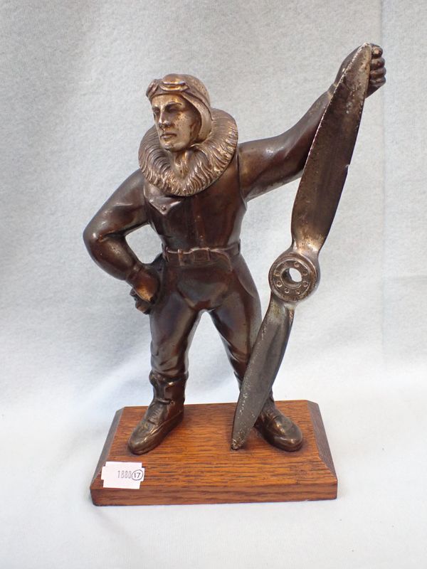 A BRONZED SPELTER TABLE LIGHTER IN THE FORM OF A PILOT