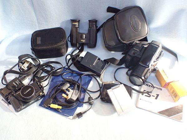 AN OLYMPUS IS-1 CAMERA, A PANASONIC LUMIX