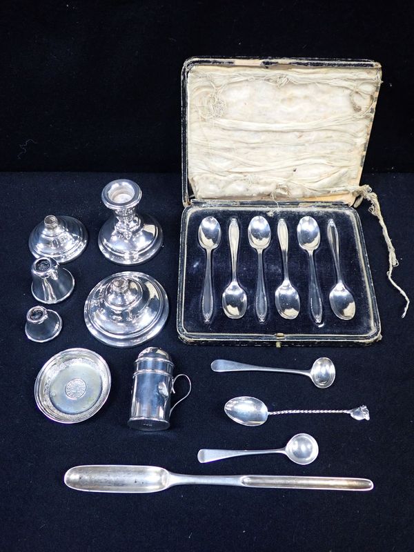 A WHITE METAL MARROW SCOOP WITH INDISTINCT MARKS, SIX SILVER TEASPOONS, DWARF CANDLESTICKS (SOME DAMAGE)