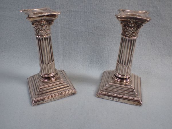 A PAIR OF SILVER CORINTHIAN COLUMN CANDLESTICKS
