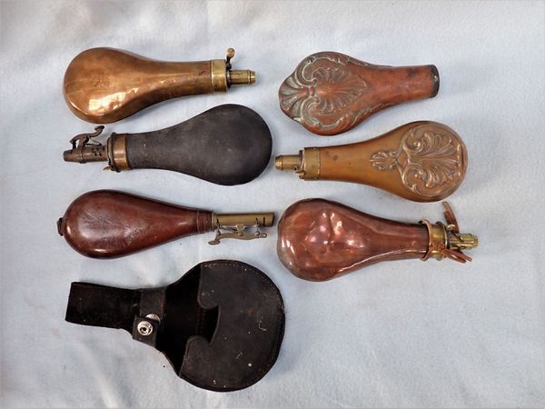A LEATHER COVERED POWDER FLASK,