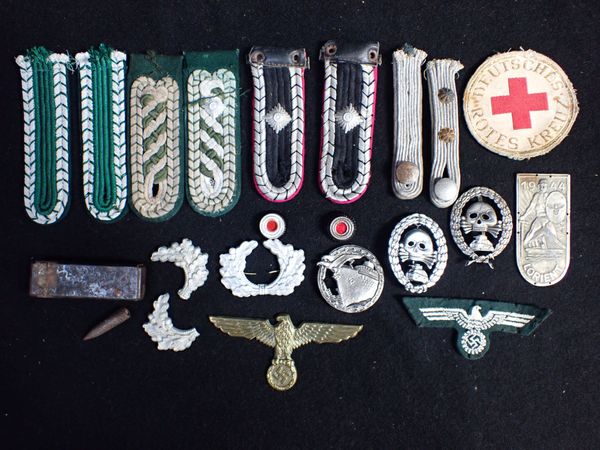 A COLLECTION OF NAZI STYLE MILITARY BADGES