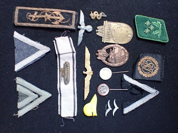 A COLLECTION OF NAZI STYLE MILITARY BADGES