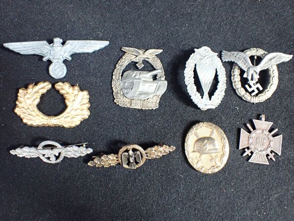 A COLLECTION OF NAZI STYLE MILITARY BADGES