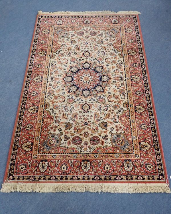 A RUSSET GROUND PERSIAN DESIGN RUG