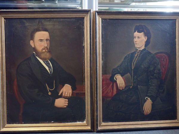 A PAIR OF NAIVELY PAINTED VICTORIAN OIL ON CANVAS PORTRAITS