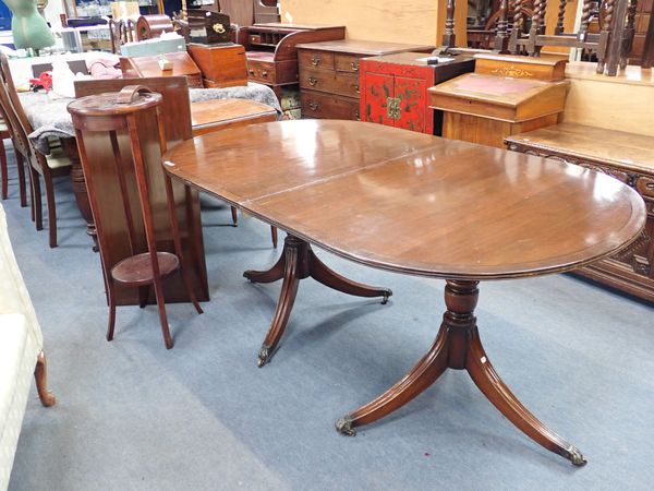 A  GEORGE III STYLE MAHOGANY TWIN PEDESTAL DINING TABLE