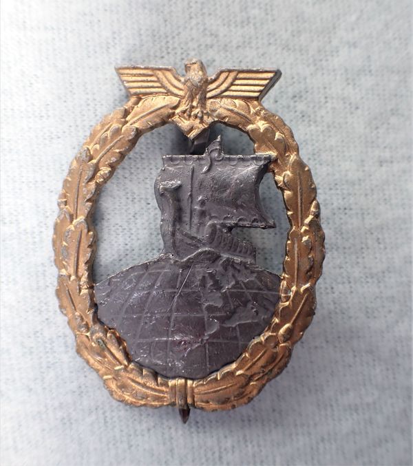 A NAZI STYLE METAL BADGE