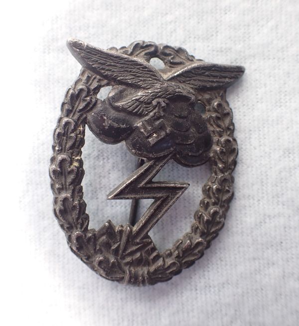 A NAZI STYLE METAL BADGE