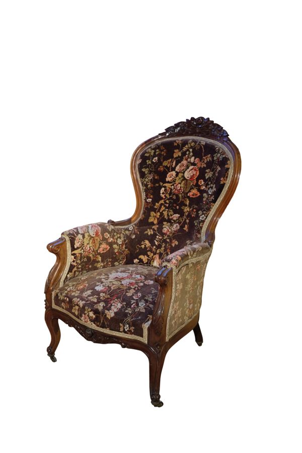 A VICTORIAN CARVED MAHOGANY 'CARPETBAG' UPHOLSTERED ARMCHAIR, MID 19TH CENTURY,