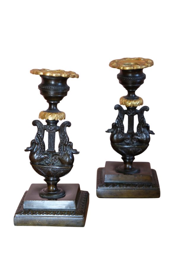 A PAIR OF EMPIRE BRONZE AND ORMOLU CANDLESTICKS