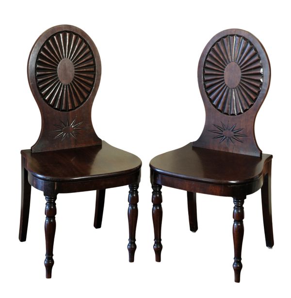 A PAIR OF GEORGE III MAHOGANY HALL CHAIRS